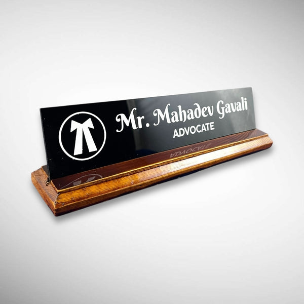 A premium desk nameplate featuring a polished wooden base with a sleek acrylic | Adv. Mahadev Gavali