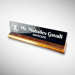A premium desk nameplate featuring a polished wooden base with a sleek acrylic | Adv. Mahadev Gavali