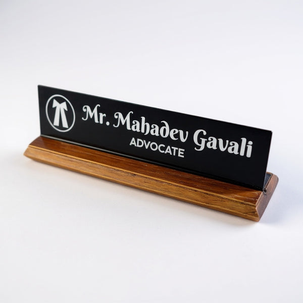 A premium desk nameplate featuring a polished wooden base with a sleek acrylic | Adv. Mahadev Gavali