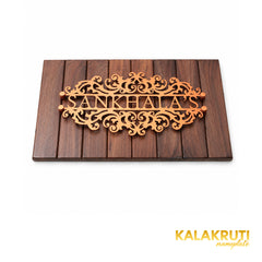 Sankhala's copper-tone nameplate on woodgrain panel, oblique detail of panel edge and four stand-offs
