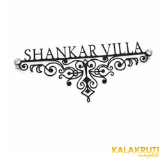Shankar Villa black ornamental nameplate, oblique detail showing the fine scrollwork and two end stand-offs