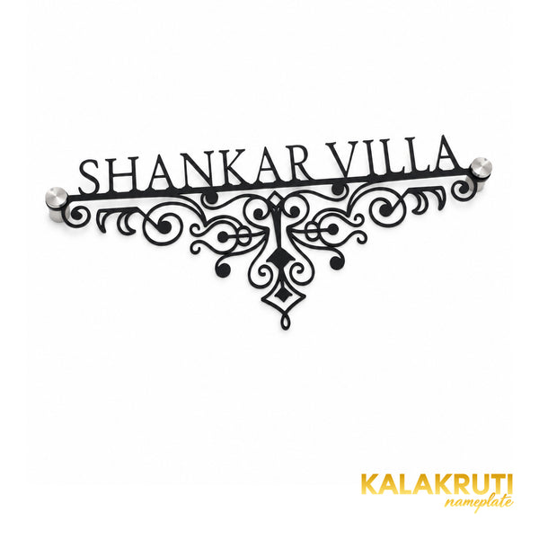 Shankar Villa black ornamental nameplate, oblique detail showing the fine scrollwork and two end stand-offs