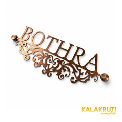 Bothra copper-tone nameplate, original diagonal oblique view of the cutout scrollwork and two end caps