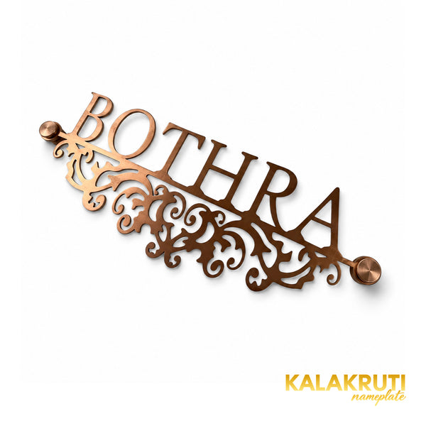Bothra copper-tone nameplate, original diagonal oblique view of the cutout scrollwork and two end caps