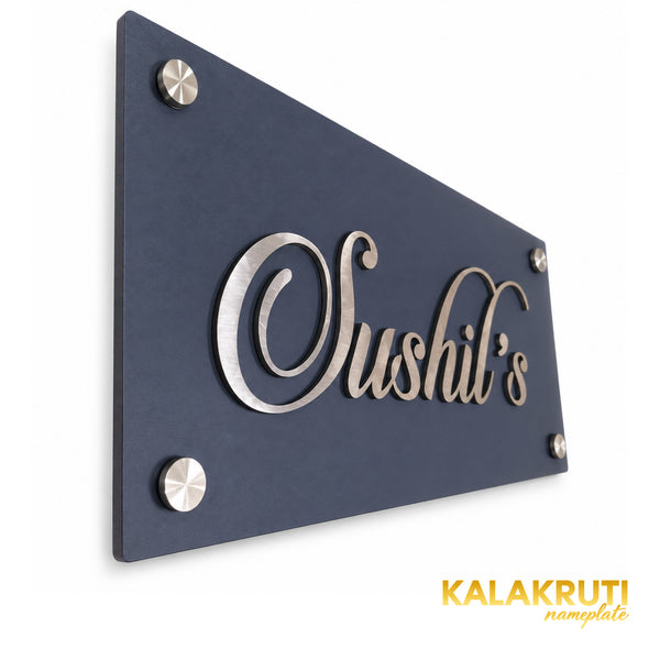 Sushil's nameplate, original oblique detail showing the thin edge and raised silver-tone script