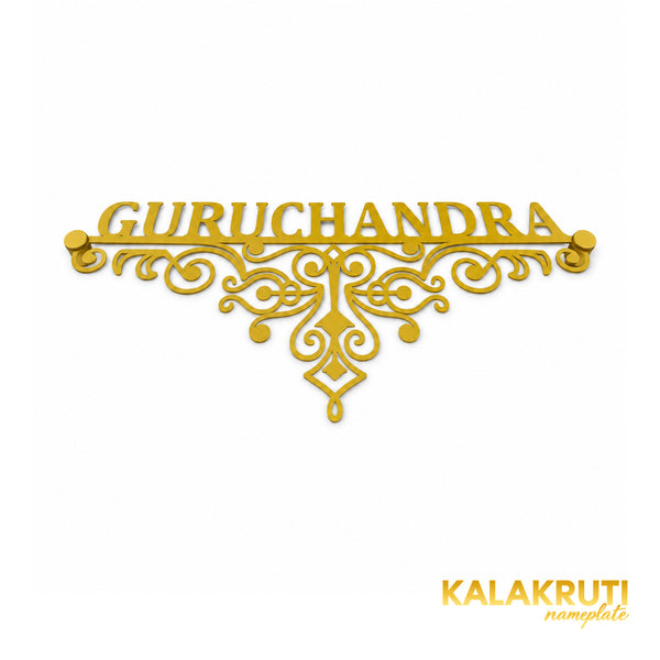 Guruchandra nameplate, original low oblique view showing the gold-tone open scrollwork and two matching caps