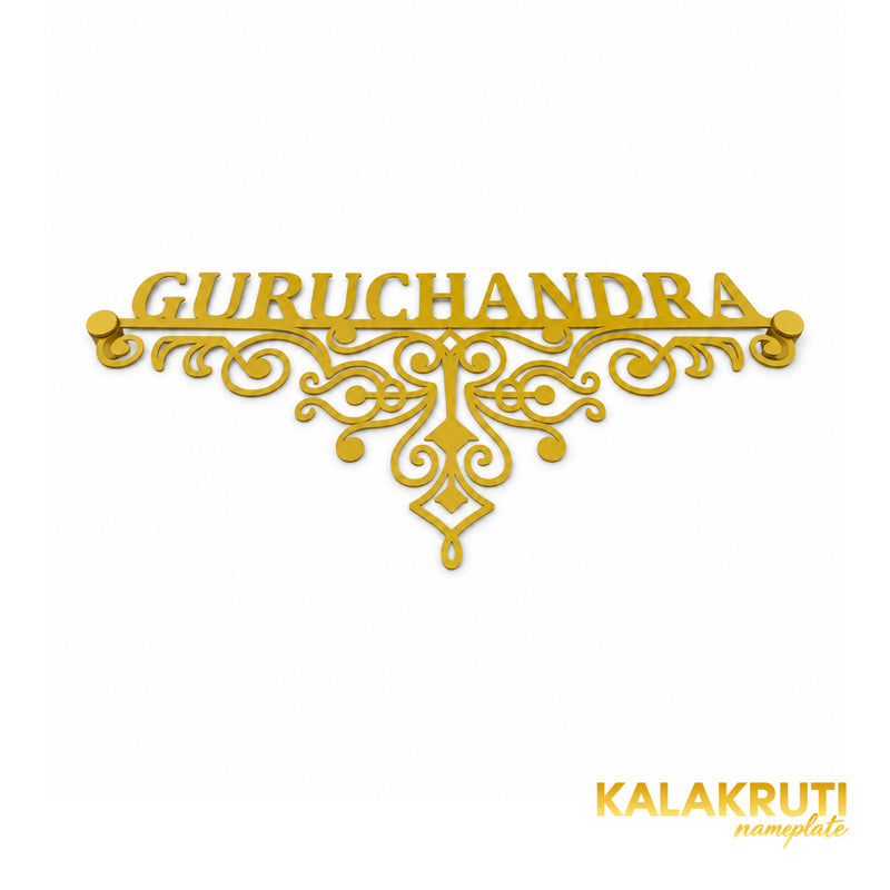 Guruchandra nameplate, original low oblique view showing the gold-tone open scrollwork and two matching caps