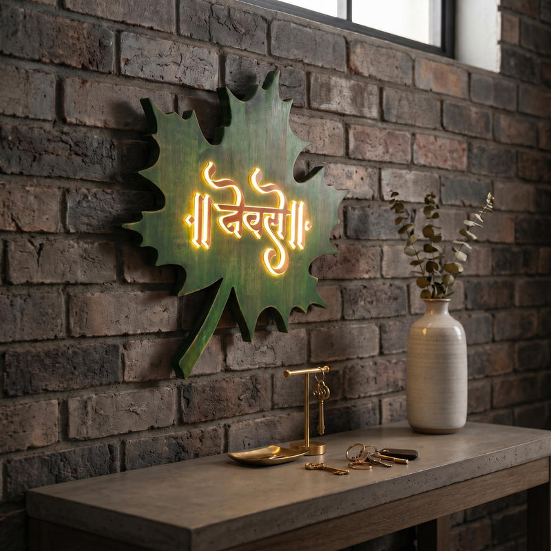 Green leaf LED nameplate with gold Devanagari lettering, installed illuminated view