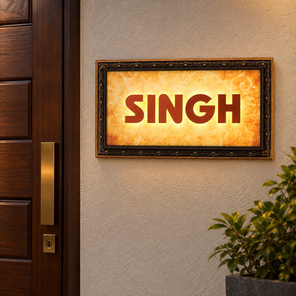 Ornate framed SINGH LED nameplate, installed illuminated view