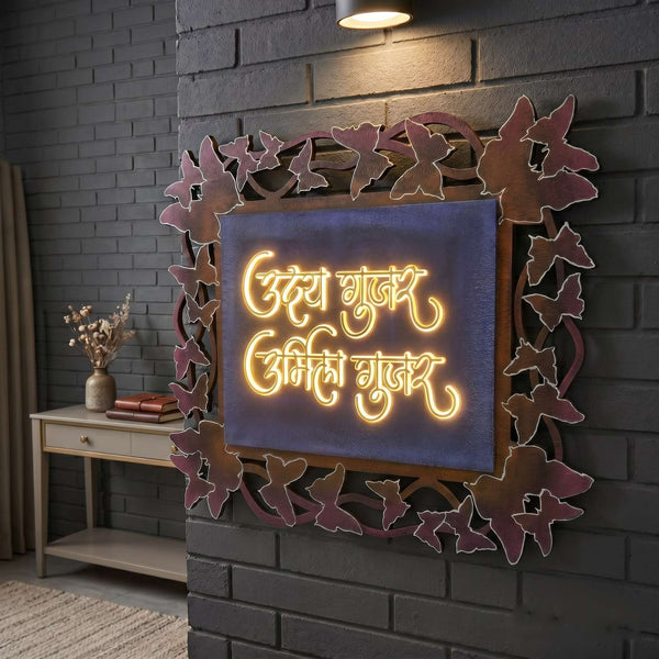 Butterfly frame LED nameplate with blue panel and gold Marathi lettering installed illuminated