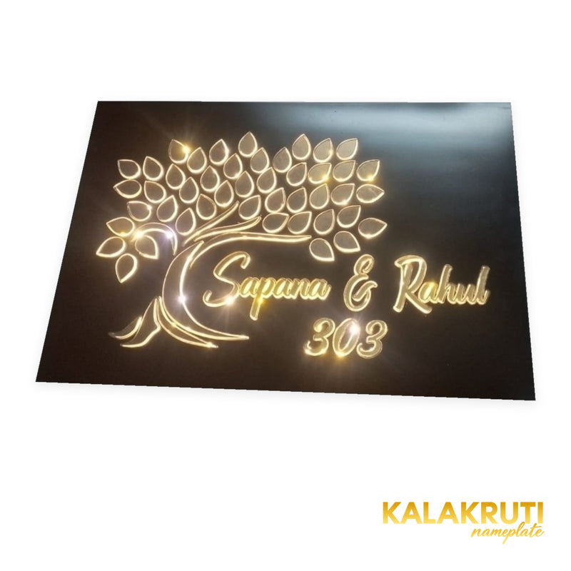 Sapana & Rahul 303 tree design LED nameplate — low angle with warm LED illumination