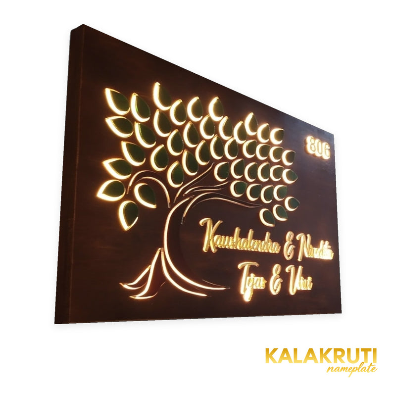 Kaushalendra & Nivedita 806 tree design wooden LED nameplate - left view with warm LED illumination
