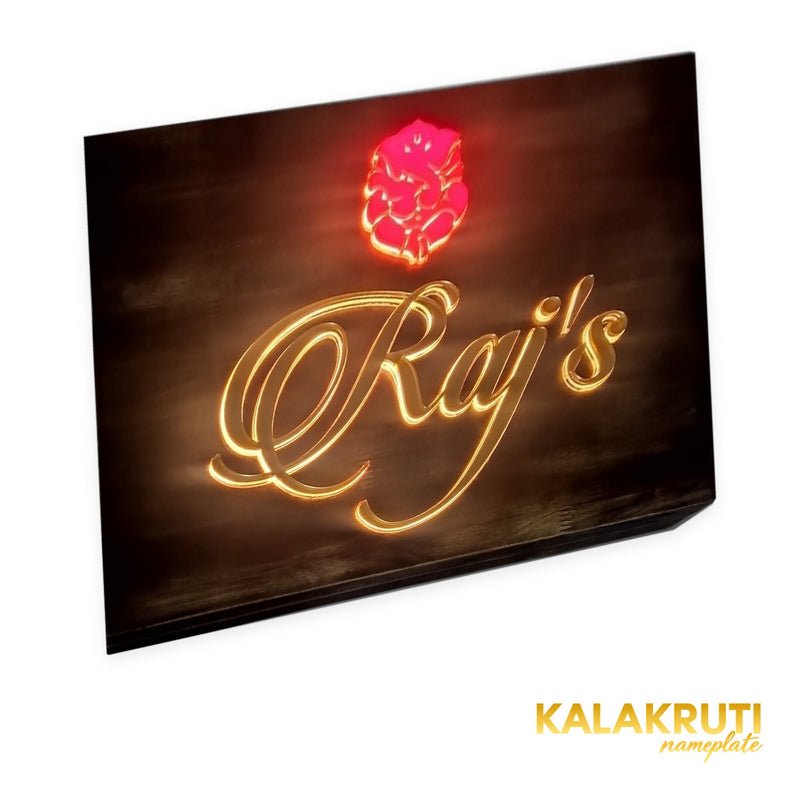 Raj’s wooden LED nameplate with gold script and orange Ganesh - left angle LED on