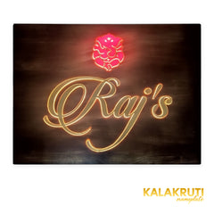 Raj’s wooden LED nameplate with gold script and orange Ganesh - front LED on in dim lighting