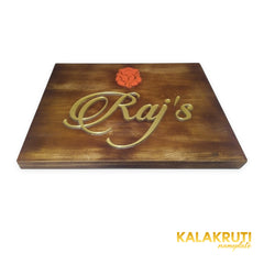 Raj’s wooden LED nameplate with gold script and orange Ganesh - low angle LED off