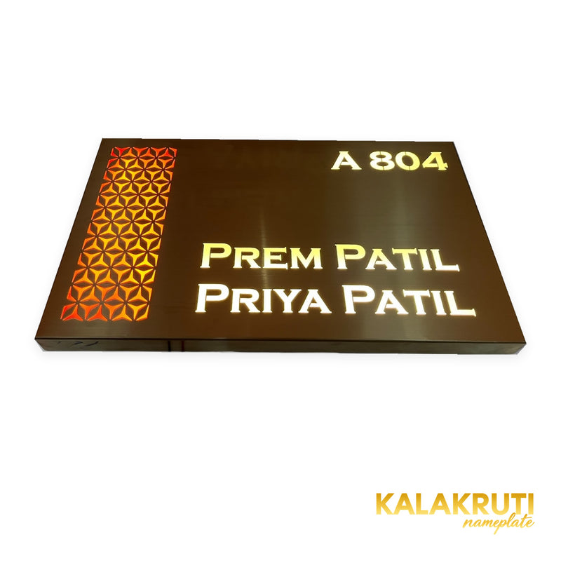 Prem Patil & Priya Patil A 804 copper-brown LED nameplate — Low angle warm LED on with original folded return