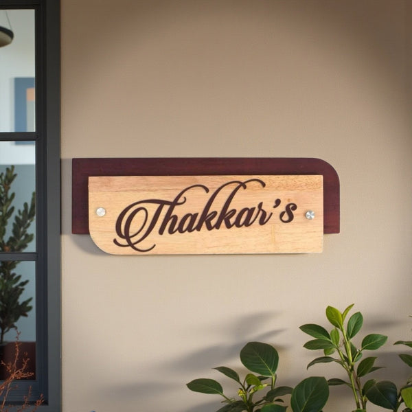 Thakkar’s wooden nameplate installed on a wall