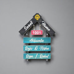 Black and Teal House Shape Wooden Nameplate | Ahluwalia — installed wall (KKWN0023)