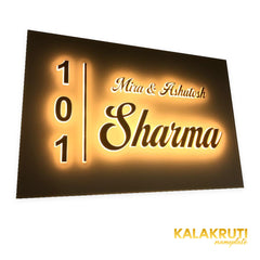 Mira & Ashutosh Sharma 101 white acrylic LED nameplate — Left angle warm LED on in low ambient light