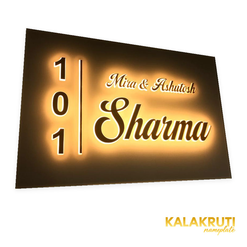 Mira & Ashutosh Sharma 101 white acrylic LED nameplate — Left angle warm LED on in low ambient light