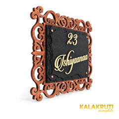 Ishiyaanaa black stone nameplate, left angle showing the ornate MDF frame and cream acrylic lettering