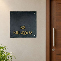 SS Nilayam nameplate shown installed beside an indoor apartment entrance door