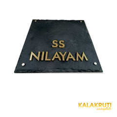 SS Nilayam nameplate, original low table camera showing brass letters and thin slab on a white studio background