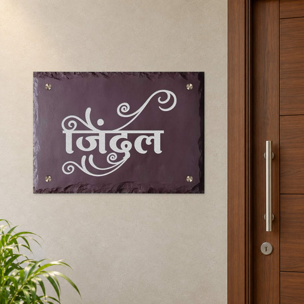 Jindal engraved brown stone calligraphy nameplate shown installed level beside an apartment door
