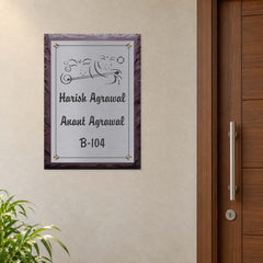 Harish and Anant Agrawal etched stainless steel and brown stone nameplate shown installed level beside an apartment entrance