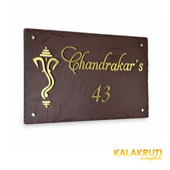 Chandrakar brown stone and brass nameplate, left oblique view preserving the original script, Ganesha motif and four silver-tone caps