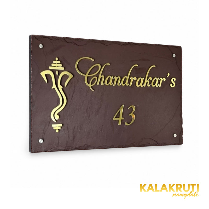 Chandrakar brown stone and brass nameplate, left oblique view preserving the original script, Ganesha motif and four silver-tone caps