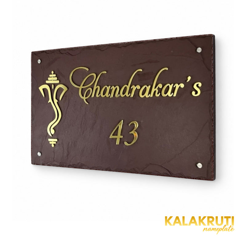 Chandrakar brown stone and brass nameplate, right oblique view preserving the original script, Ganesha motif and four silver-tone caps
