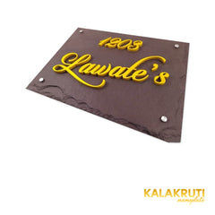 Lawate nameplate, low right tabletop angle showing the yellow acrylic depth on a white studio background