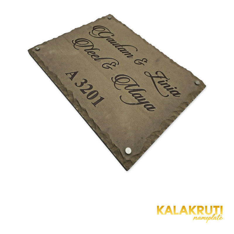 Gautam & Family nameplate, original low diagonal angle showing the engraving and chipped stone edge on a white studio background