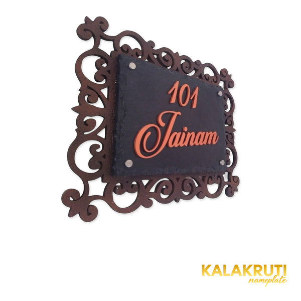Jainam nameplate, left oblique view on a white studio background