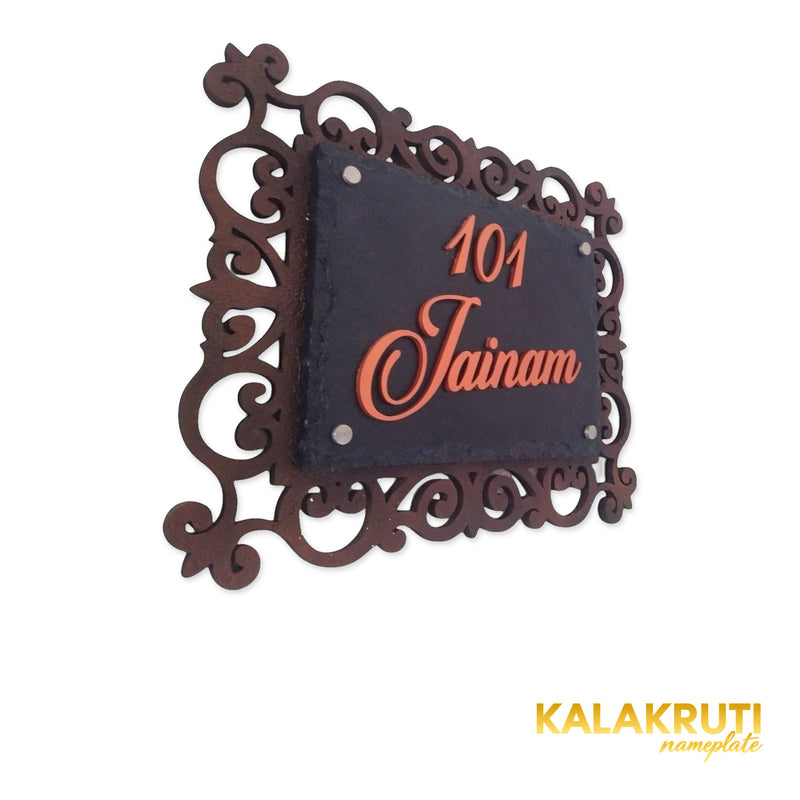 Jainam nameplate, left oblique view on a white studio background