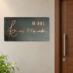 Kalpak nameplate shown installed beside an indoor apartment entrance door