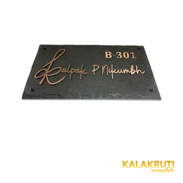 Kalpak nameplate, low front view of copper lettering and the chipped stone edge on a white studio background